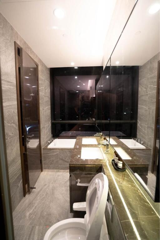 modern bathroom with dual sinks and a bathtub