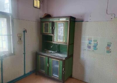 Small kitchen area with a sink and storage cabinet