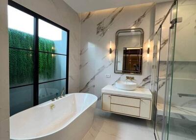 Modern bathroom with freestanding tub and glass-enclosed shower