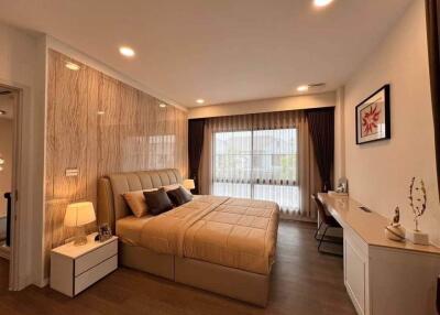 Modern bedroom with stylish decor and ample natural light