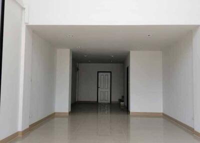 Spacious main living area with high ceiling and second-floor windows