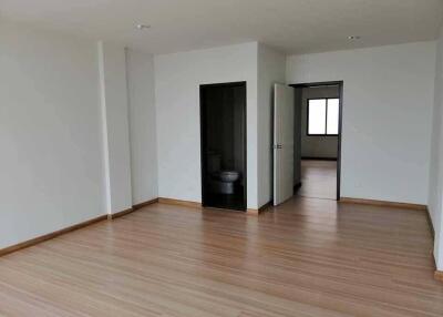 Spacious empty living area with wooden flooring