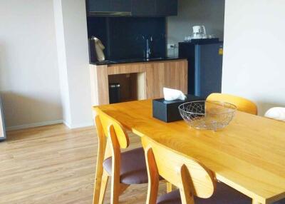 Modern dining area with table and kitchen view