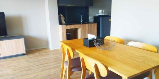 Modern dining area with table and kitchen view