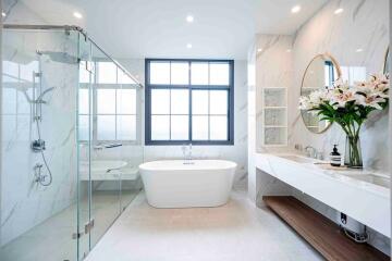 Well-lit modern bathroom with a bathtub and a glass shower