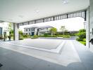 View of a spacious and modern house exterior with a large driveway and landscaped garden