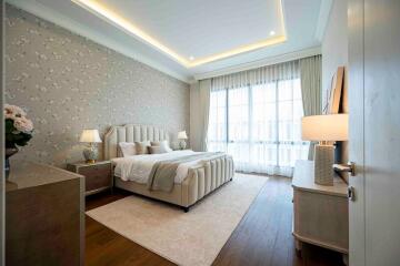 Spacious and well-lit bedroom with cozy decor and modern furniture