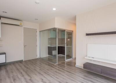 Modern living room with wooden flooring and glass-enclosed area