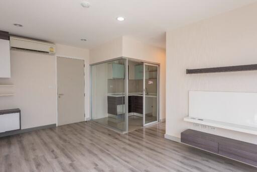 Modern living room with wooden flooring and glass-enclosed area