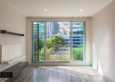 Bright living room with large window and city view