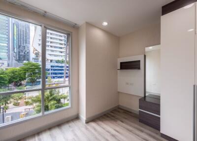 Bright bedroom with large window and modern furnishings