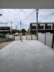 Driveway with open gate leading to the street