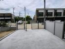 Driveway with open gate leading to the street