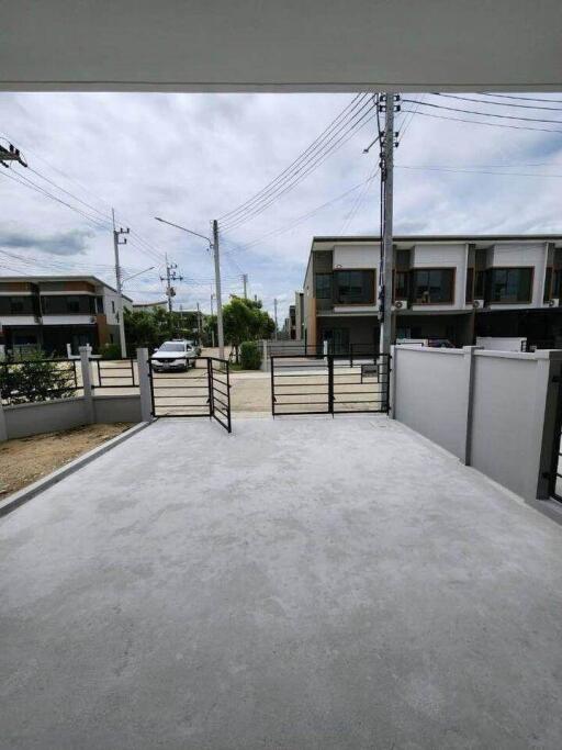 Driveway with open gate leading to the street