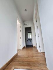 Bright and clean hallway with wooden floors