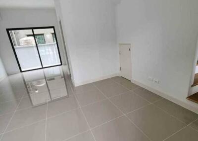 Spacious living room with tiled floor and large window