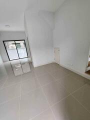 Spacious living room with tiled floor and large window