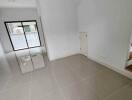 Spacious living room with tiled floor and large window