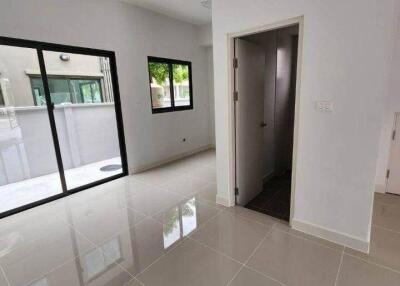 Bright living room with large windows and a door.