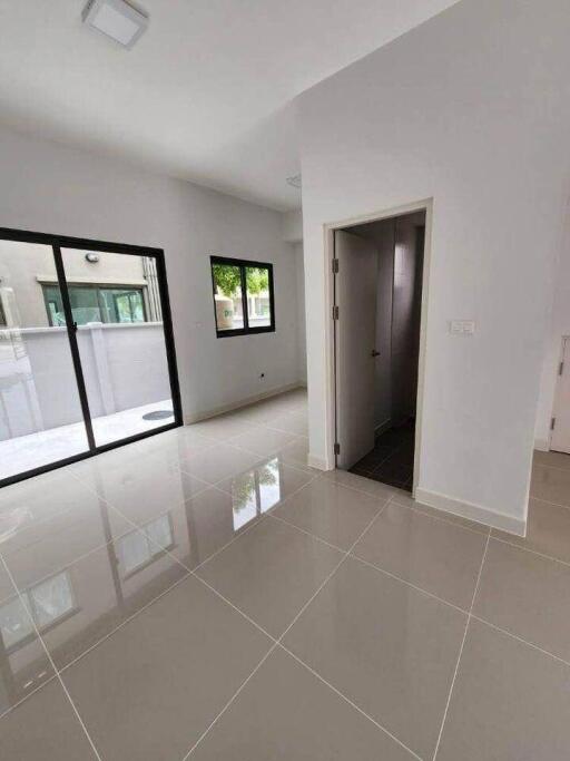 Bright living room with large windows and a door.