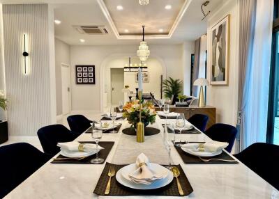 Elegant dining area with a long table set for a meal