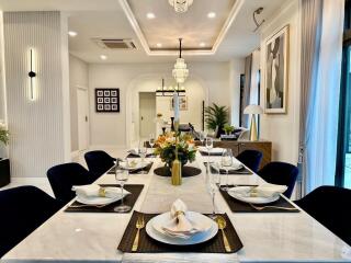 Elegant dining area with a long table set for a meal