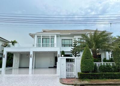 Front view of a modern two-story house with a driveway.