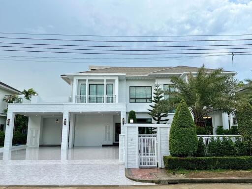 Front view of a modern two-story house with a driveway.