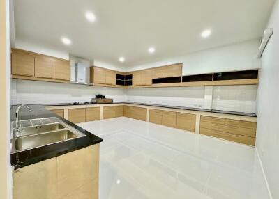 Modern kitchen with wooden cabinetry and tiled floor