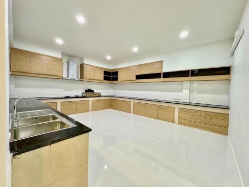 Modern kitchen with wooden cabinetry and tiled floor