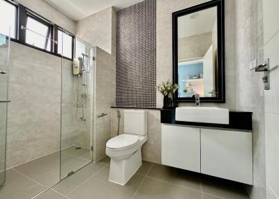 Modern bathroom with shower, toilet, and sink