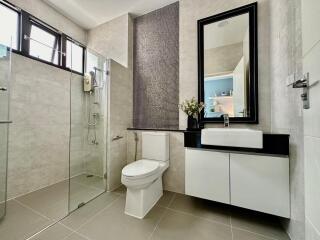 Modern bathroom with shower, toilet, and sink