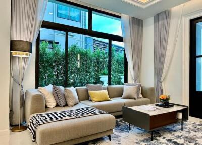 Modern living room with large windows and a comfortable sectional sofa