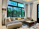 Modern living room with large windows and a comfortable sectional sofa