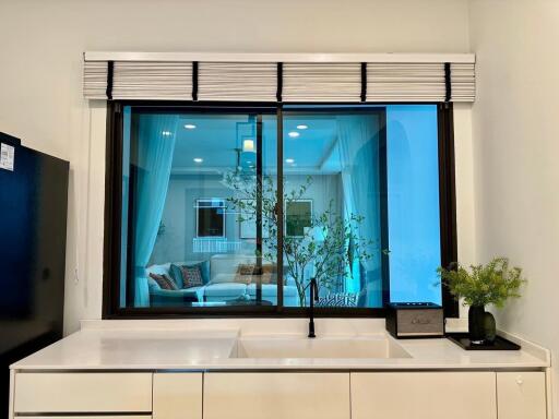 Kitchen view with a window overlooking a living room