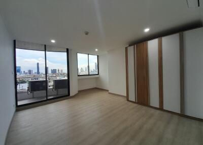 Spacious living area with large windows offering city views