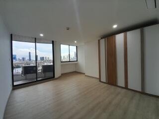 Spacious living area with large windows offering city views