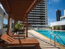 Outdoor swimming pool area with seating