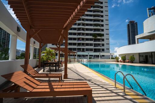 Outdoor swimming pool area with seating