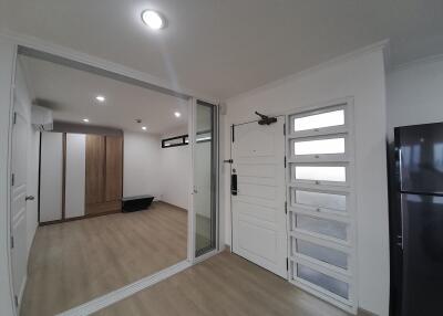 Modern living area with wooden flooring and glass partition