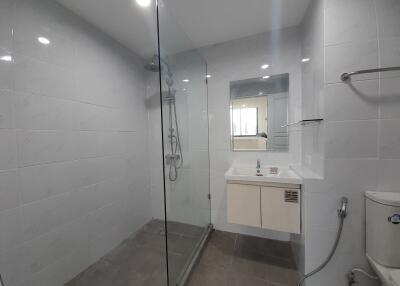 Modern bathroom with glass shower enclosure and vanity