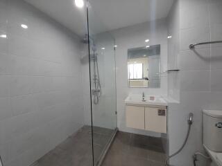 Modern bathroom with glass shower enclosure and vanity