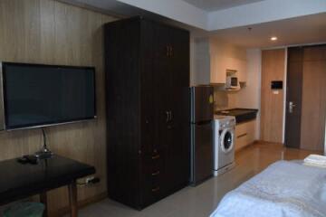 Bedroom with wardrobe, TV, and kitchenette