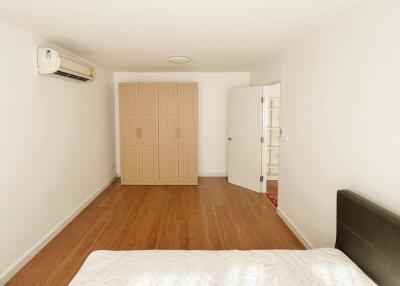 Bedroom with wooden wardrobe and air conditioning