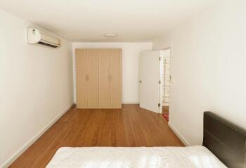 Bedroom with wooden wardrobe and air conditioning