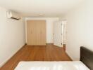 Bedroom with wooden wardrobe and air conditioning