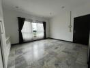 Spacious empty living room with tiled flooring and large window with curtains