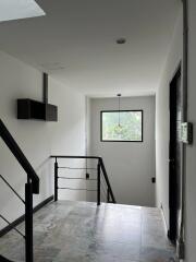 Indoor hallway with a window providing natural light