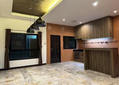 Modern kitchen with integrated lighting and open dining area