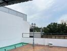 Rooftop area with wooden deck and light post